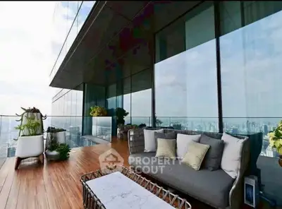 Luxurious high-rise balcony with stunning city views and modern outdoor seating.