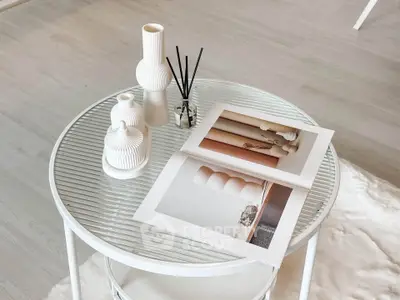 Elegant modern interior with stylish decor on a glass table, showcasing minimalist design.