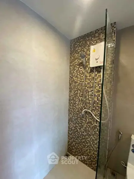 Modern bathroom with tiled shower and glass partition
