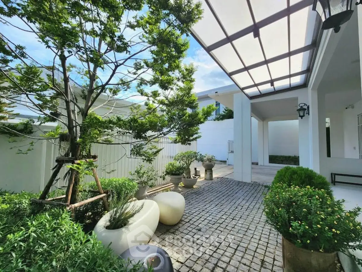 Charming garden patio with lush greenery and modern design