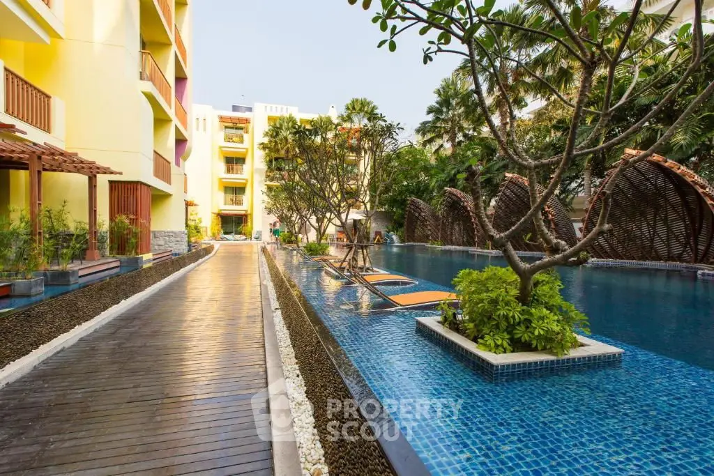 Luxurious apartment complex with stunning pool and lush greenery