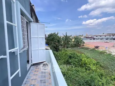 Charming balcony view overlooking lush greenery and open sky