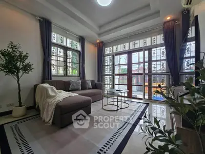 Spacious living room with large windows and modern decor