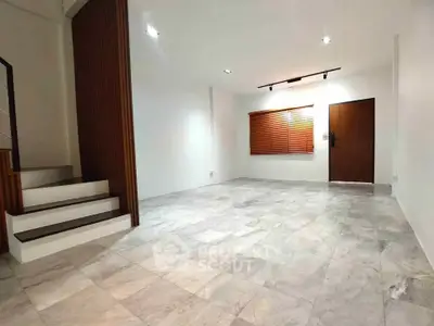 Spacious modern living room with elegant staircase and stylish lighting