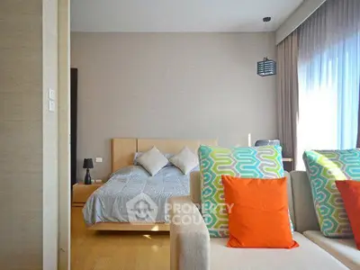 Modern bedroom with stylish decor and natural light in a contemporary apartment.
