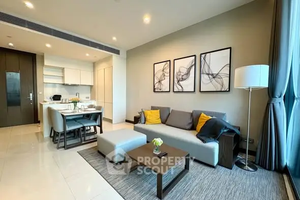Modern living room with open kitchen, stylish decor, and ample natural light in a contemporary apartment.