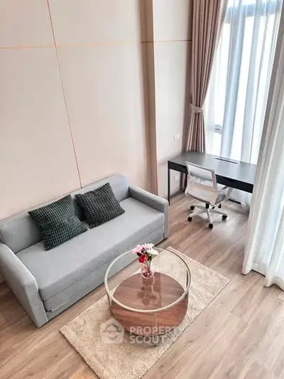 Modern living room with stylish sofa and workspace in bright apartment