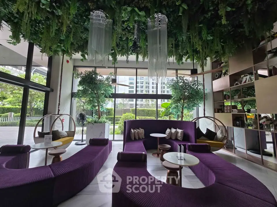 Luxurious modern lobby with unique seating and lush greenery, perfect for relaxation and social gatherings.