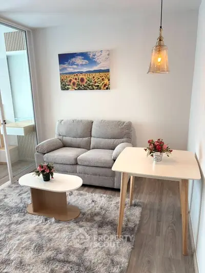 Charming living room with cozy sofa, stylish decor, and bright lighting in modern apartment.