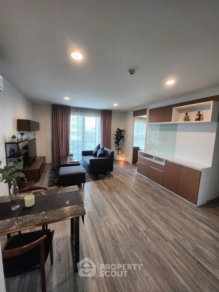 Modern living room with stylish furniture and large windows for natural light.