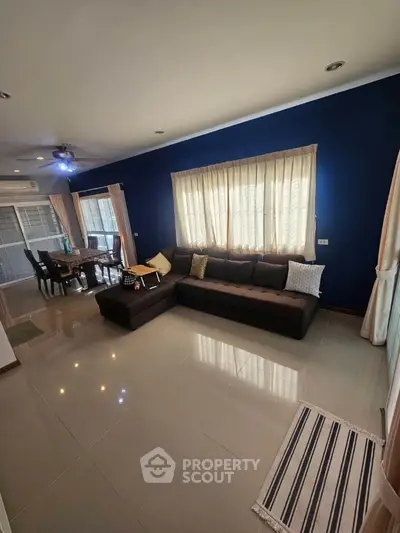 Spacious living room with modern decor and large windows for natural light