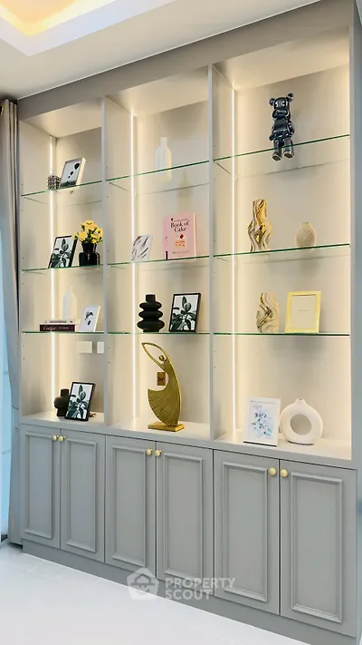 Elegant built-in shelving with decorative items in a modern living room setting.