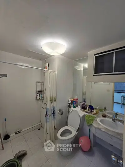 Spacious bathroom with modern fixtures and ample storage space.