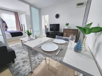 Modern open-plan living room with dining area and bedroom, featuring stylish decor and natural light.