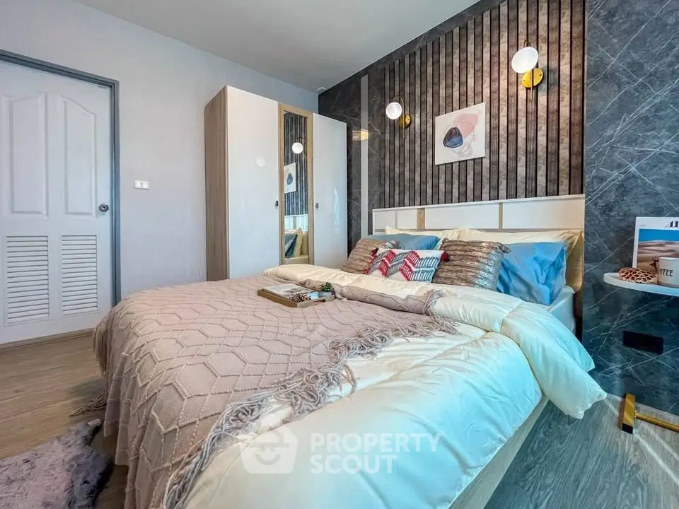 Modern bedroom with stylish decor and cozy bedding in a contemporary apartment.