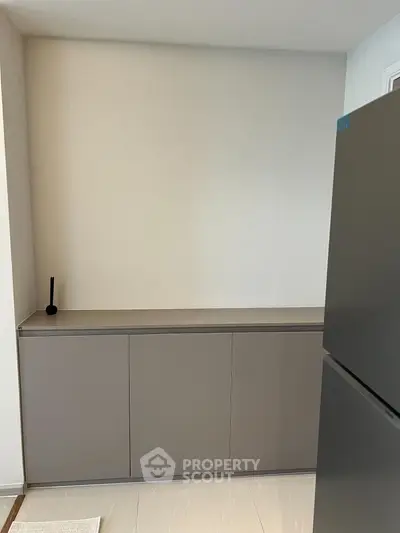 Modern kitchen with sleek cabinetry and stainless steel fridge, perfect for contemporary living.