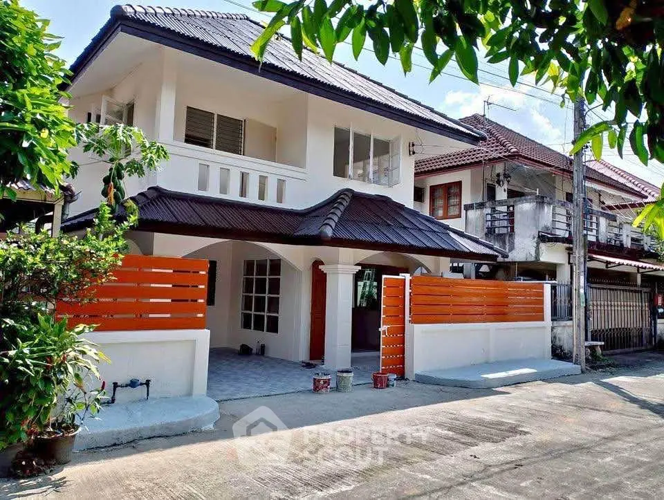 Charming two-story house with modern design and spacious front yard in a serene neighborhood.