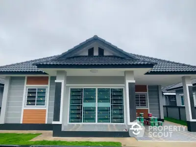 Modern single-story house with tiled roof and spacious front yard