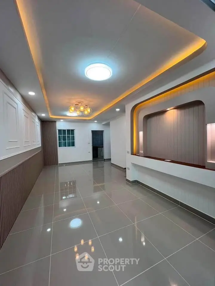 Modern living room with elegant lighting and glossy tiled flooring
