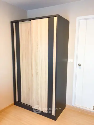 Modern wooden wardrobe in a minimalist bedroom setting