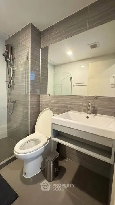 Modern bathroom with sleek fixtures and glass shower enclosure