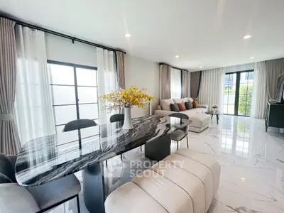 Spacious modern living room with elegant marble dining table and cozy seating area.