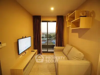 Cozy living room with modern decor and balcony view in a stylish apartment.