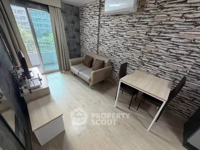Modern living room with stylish stone accent wall and balcony access
