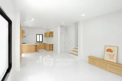 Spacious modern living room with open kitchen and minimalist design