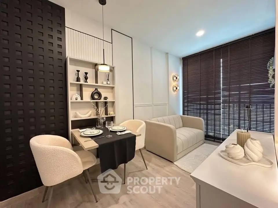 Stylish modern living room with elegant dining area and cozy seating, featuring chic decor and ample natural light.