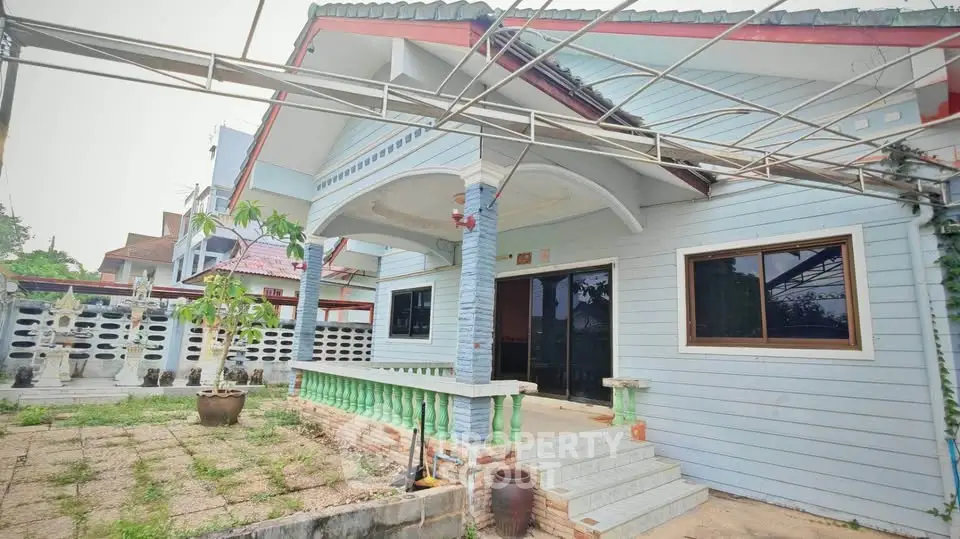 Charming single-story home with spacious front yard and unique architectural details.