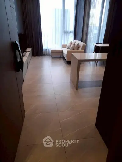 Modern living room with large windows and stylish furniture in a high-rise apartment.