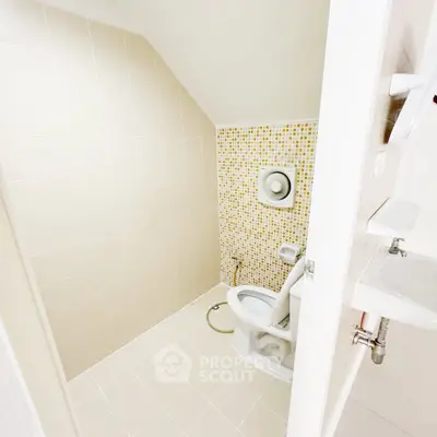 Compact bathroom with modern fixtures and tiled walls