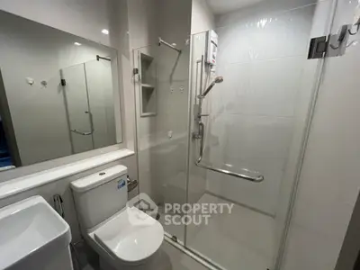 Modern bathroom with glass shower enclosure and sleek fixtures