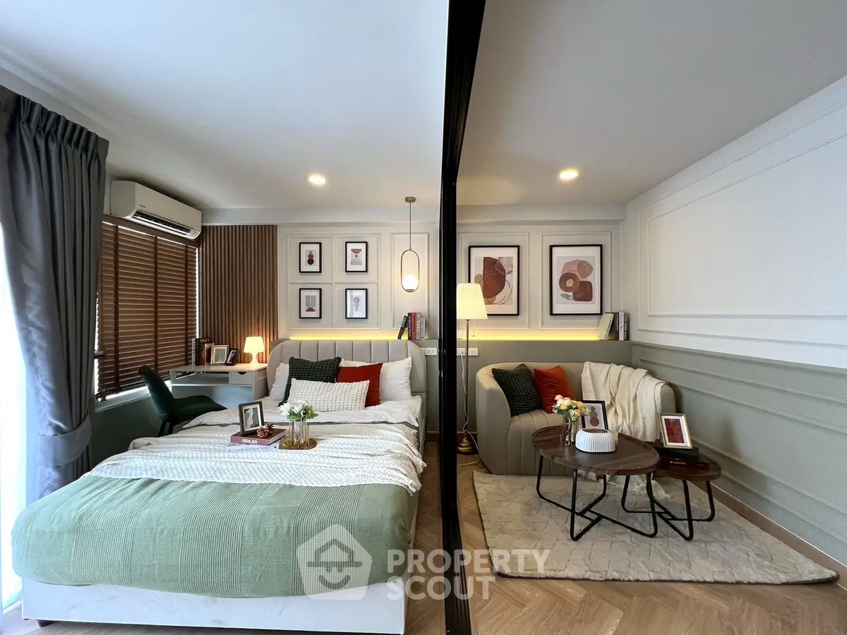 Modern bedroom with stylish decor and cozy seating area, featuring elegant wall art and soft lighting.