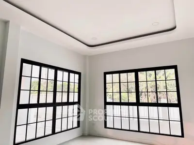 Modern interior with large windows and sleek ceiling design