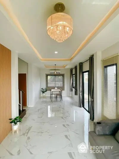 Elegant living room with modern chandelier and marble flooring