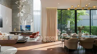 Luxurious modern living room with high ceilings and elegant dining area, featuring floor-to-ceiling windows and stylish decor.