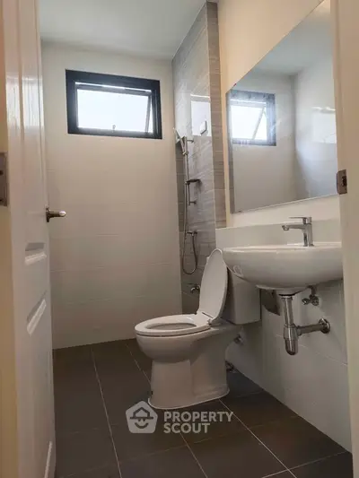 Modern bathroom with sleek fixtures and large mirror