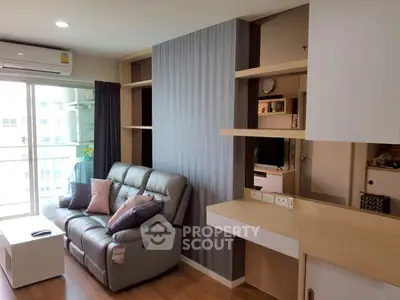 Modern living room with sleek design and natural light, featuring a comfortable sofa and stylish shelving.