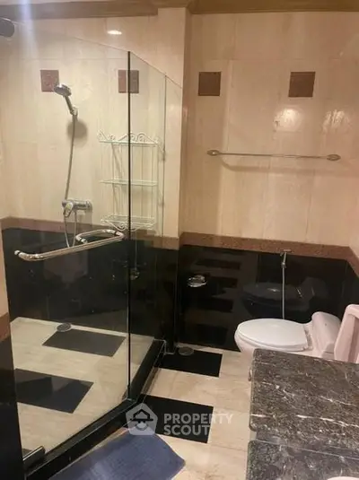 Luxurious bathroom with elegant marble finishes and modern shower enclosure.