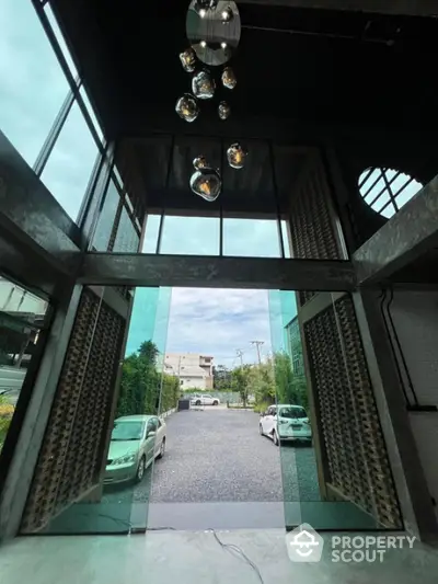 Modern entrance with glass doors and high ceiling in luxury property