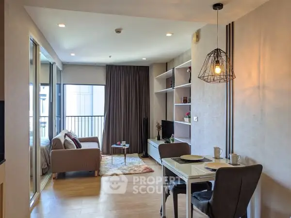 Modern living room with dining area and balcony access in stylish apartment.