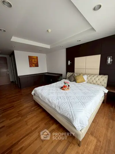 Luxurious bedroom with elegant decor and wooden flooring in modern real estate property.