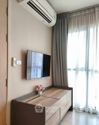 Modern living room with sleek TV setup and air conditioning