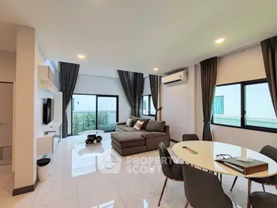 Spacious modern living room with large windows and stylish furniture