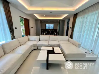 Luxurious modern living room with large white sectional sofa and stylish coffee table