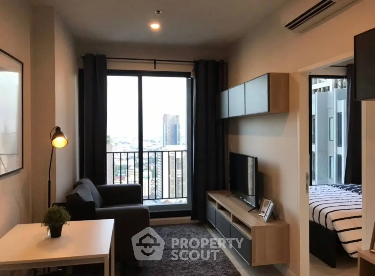 Modern living room with city view, cozy sofa, and sleek entertainment unit.