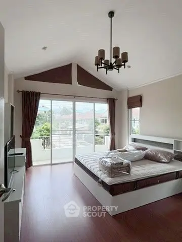 Spacious bedroom with large windows and modern decor