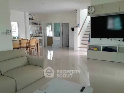 Spacious modern living room with sleek furniture and open dining area